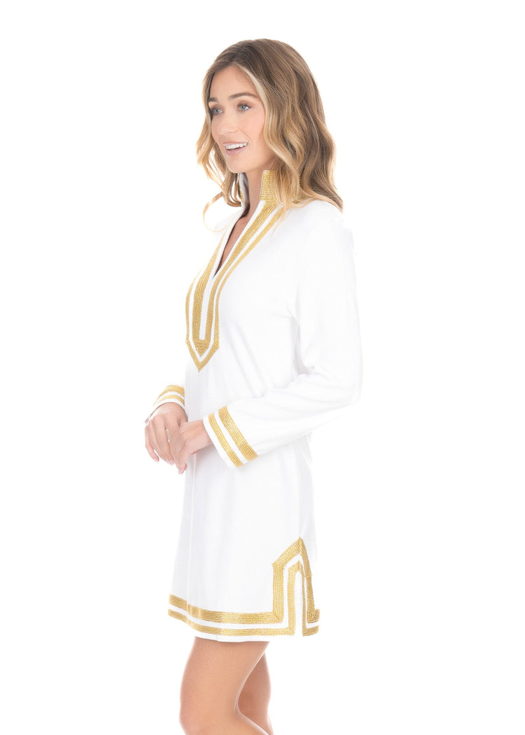 The side view of a woman wearing the comfortable UPF50+ Cabana Life White/Gold Terry Tunic. 