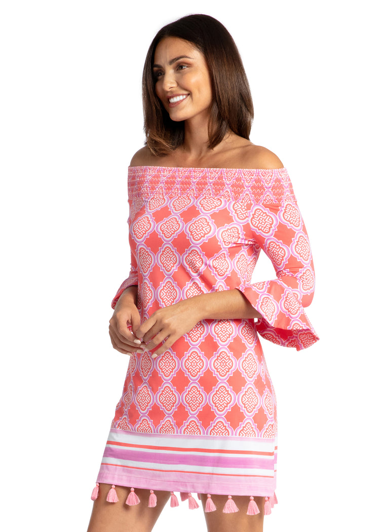 Woman modeling side of Coral Geo Off The Shoulder Dress.