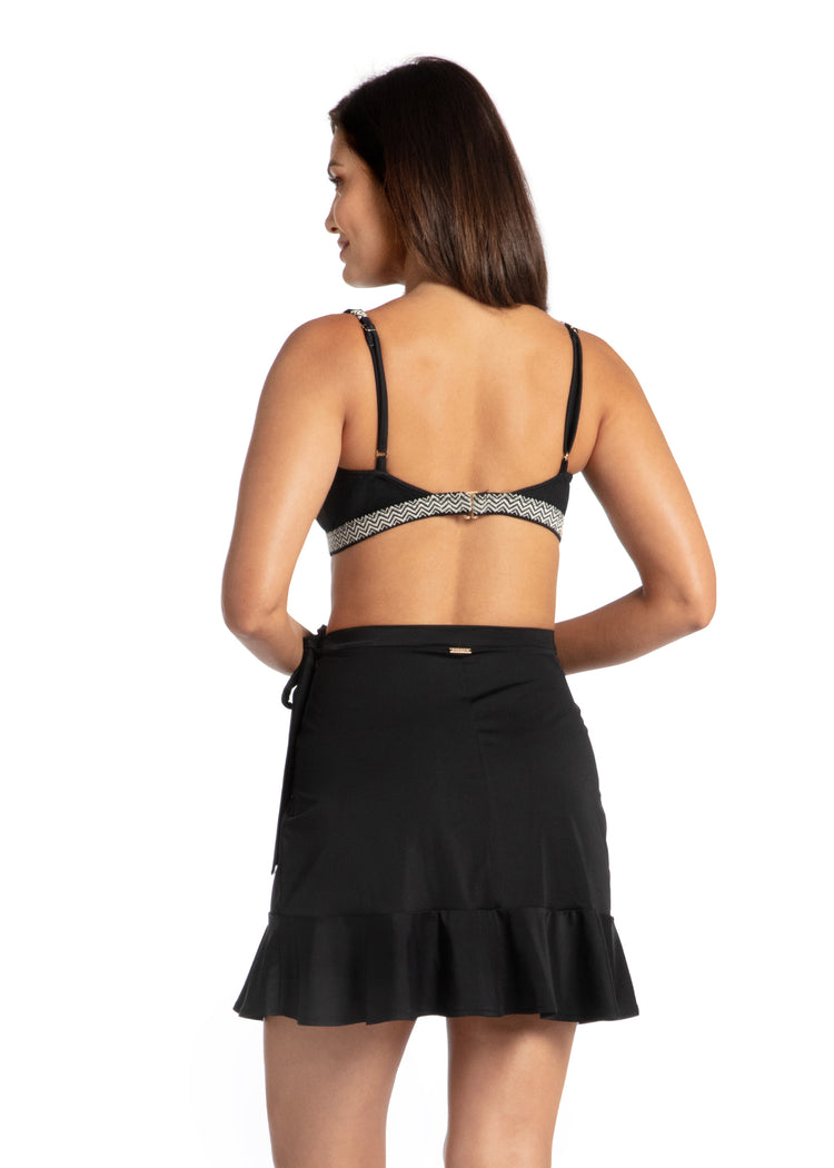 Woman wearing Sanibel Reversible Bikini Top Black Wrap Skirt