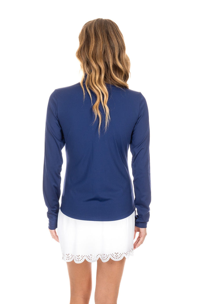 The back view of a woman wearing the UPF50+ White Scallop Skort from Cabana Life.