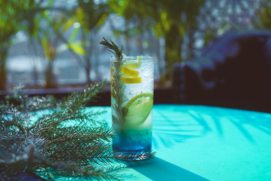 A blue cocktail sitting on a table.