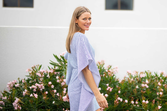 Woman walking in front of flowers wearing Navy Stripe Terry Cover Up