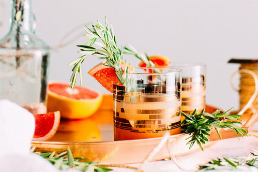 Grapefruit cocktail in glass with rosemary and grapefruit garnish
