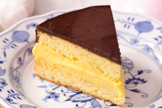 Slice of Boston Cream Pie on blue and white floral plate