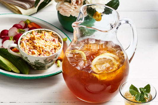 Spiked Arnold Palmer in pitcher with ice and lemon slices