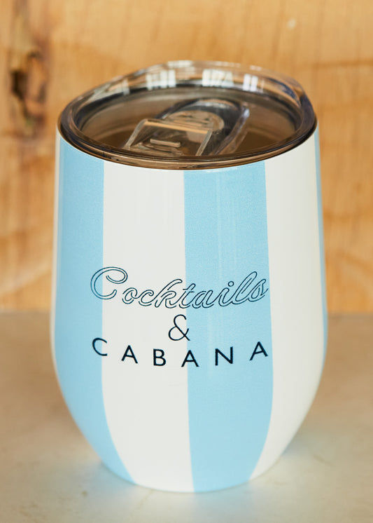 A Cocktails & Cabana Striped Stemless Wine Tumbler on white counter and wood background.