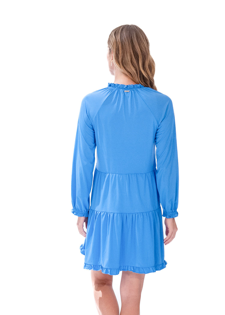 Back of blonde model wearing Periwinkle Blue Embroidered Tiered Dress in front of white background. 