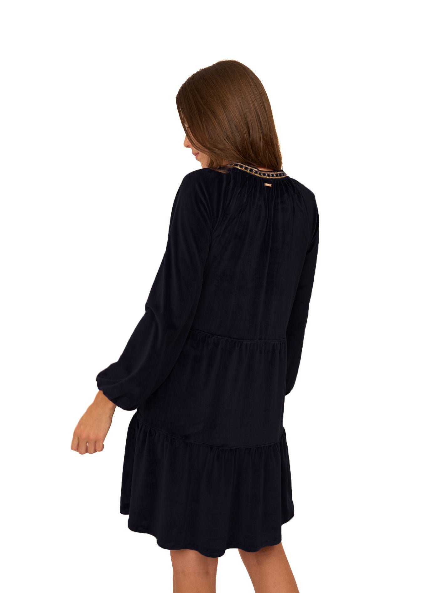 Back of a brunette woman wearing the Cabana Life sun protective Black Embroidered Velvet Tiered Dress on a white background.