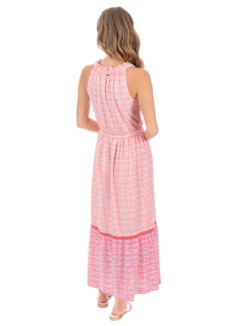 Back facing blonde model wearing the Algarve Tie Neck Maxi Dress while posing.