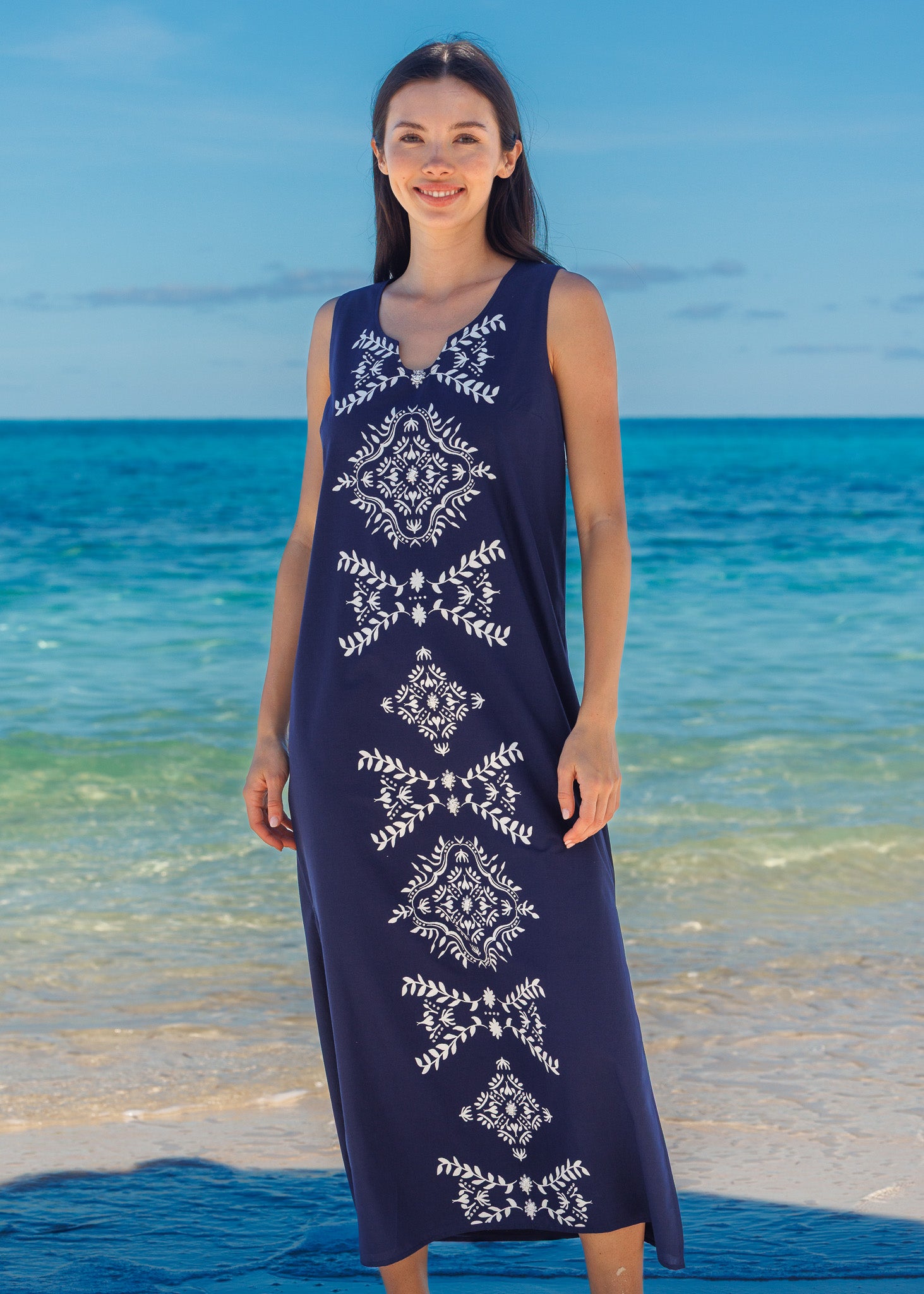 Woman wearing a navy maxi dress on the beach. 