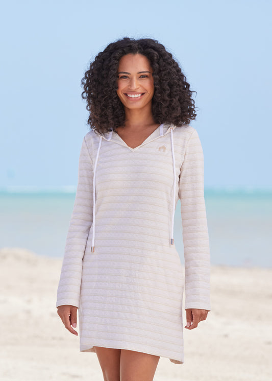 Black woman wearing Cream Hoodie Dress on beach.