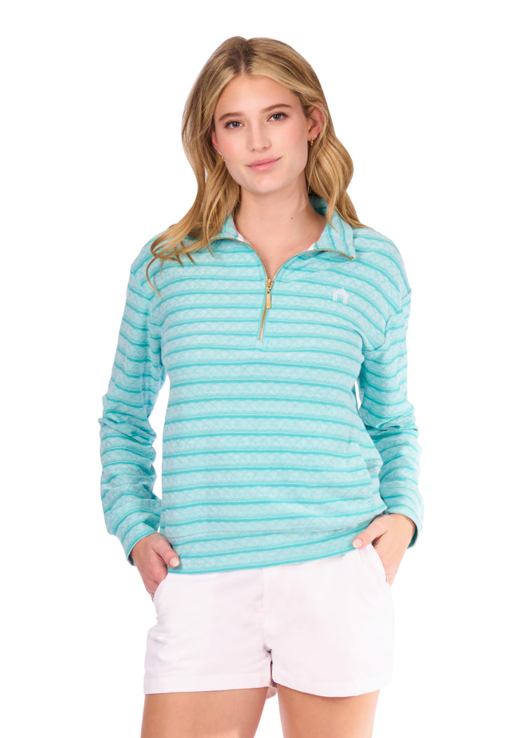 Woman in Aqua Half Zip Pullover and white shorts