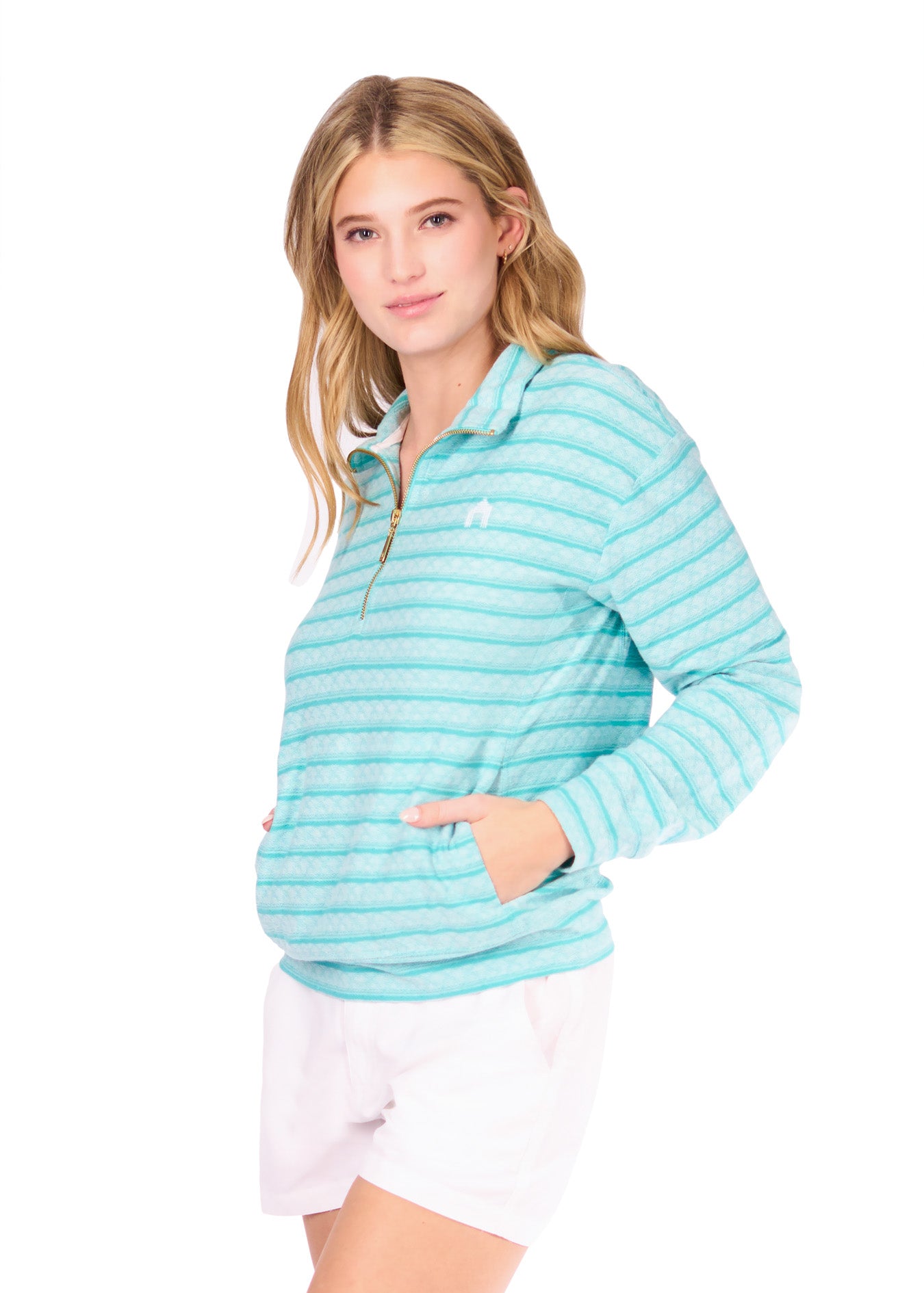 Side of woman in Aqua Half Zip Pullover and white shorts