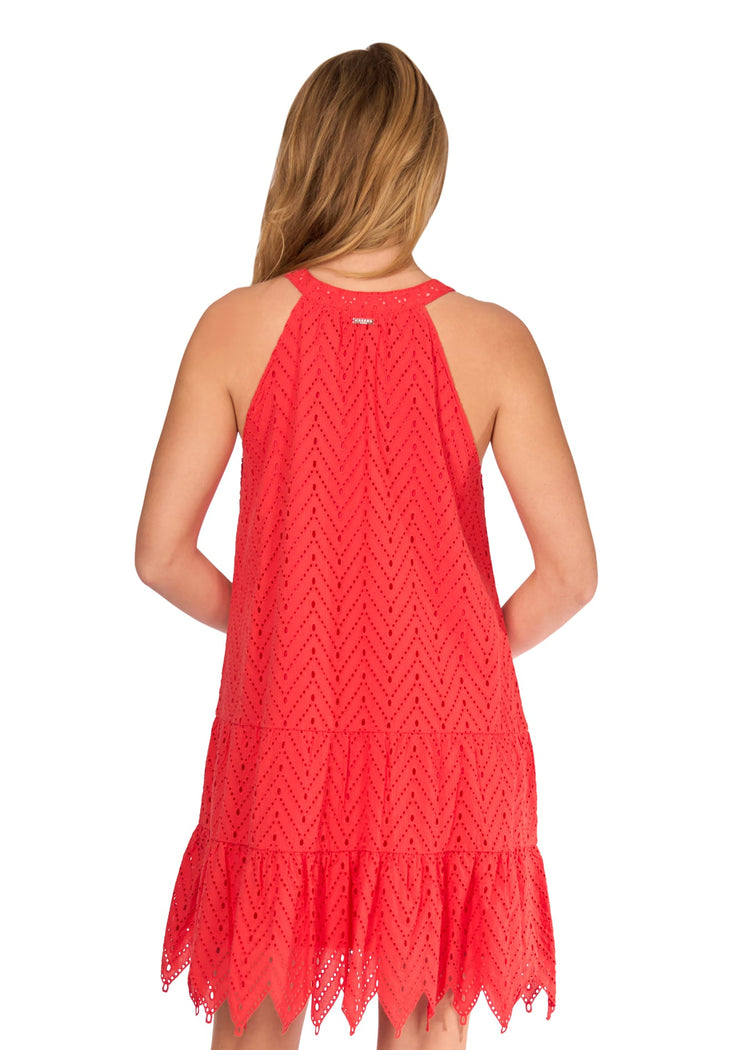 The back of a blonde woman in front of a white background wearing the Poppy Red Eyelet Halter Dress.