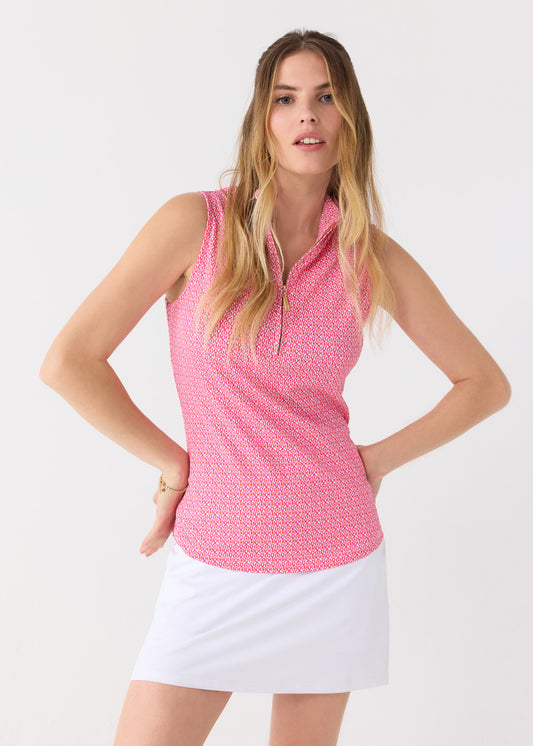 A blonde woman with hands on her hips wearing the Cabana Life sun safe Amelia Island 1/4 Zip Sleeveless Sport Top with a White 15" Skort.