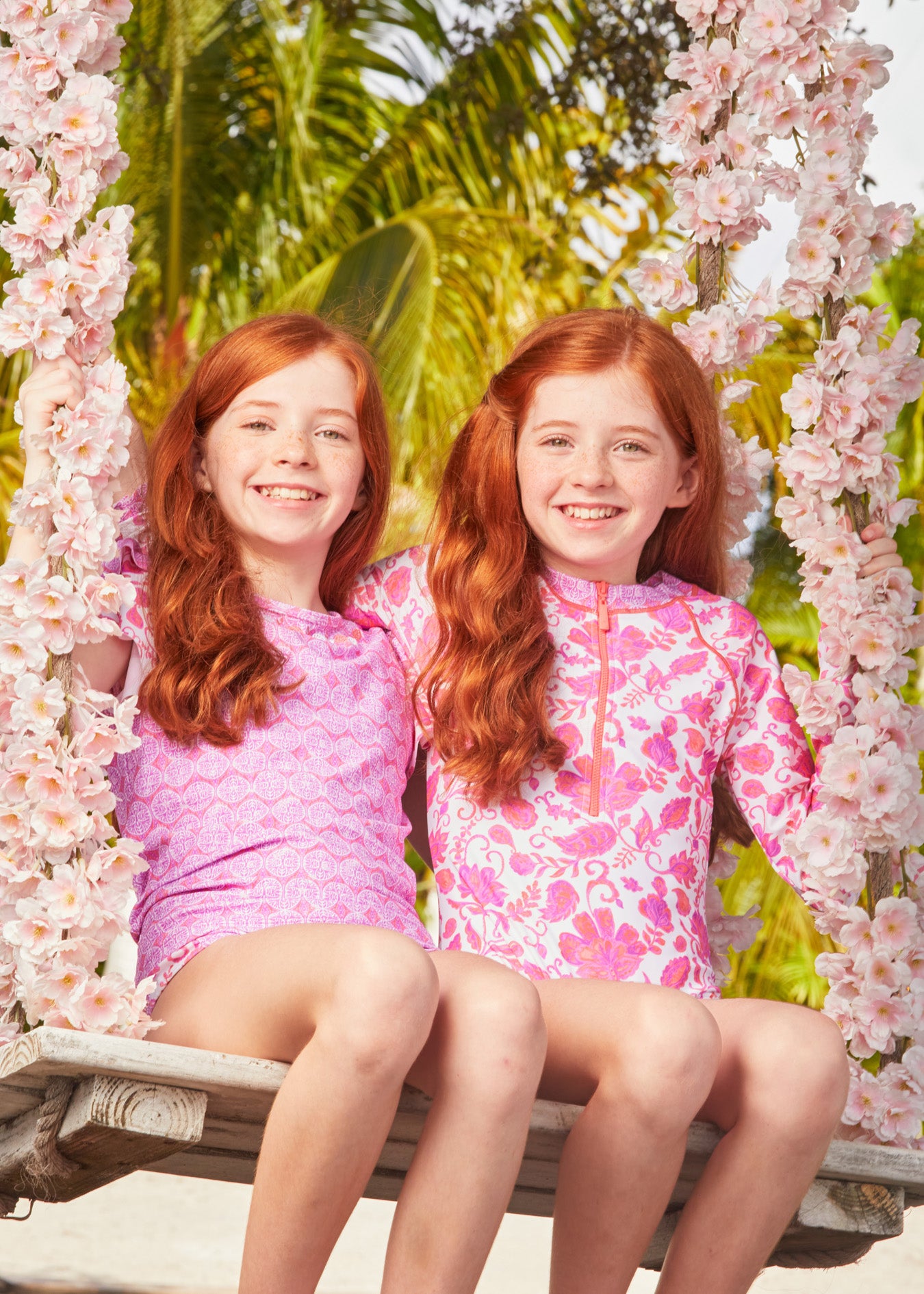 Redhead twins on flower wooden swing wearing Provence Short Sleeve Rashguard Set and Provence Unisuit