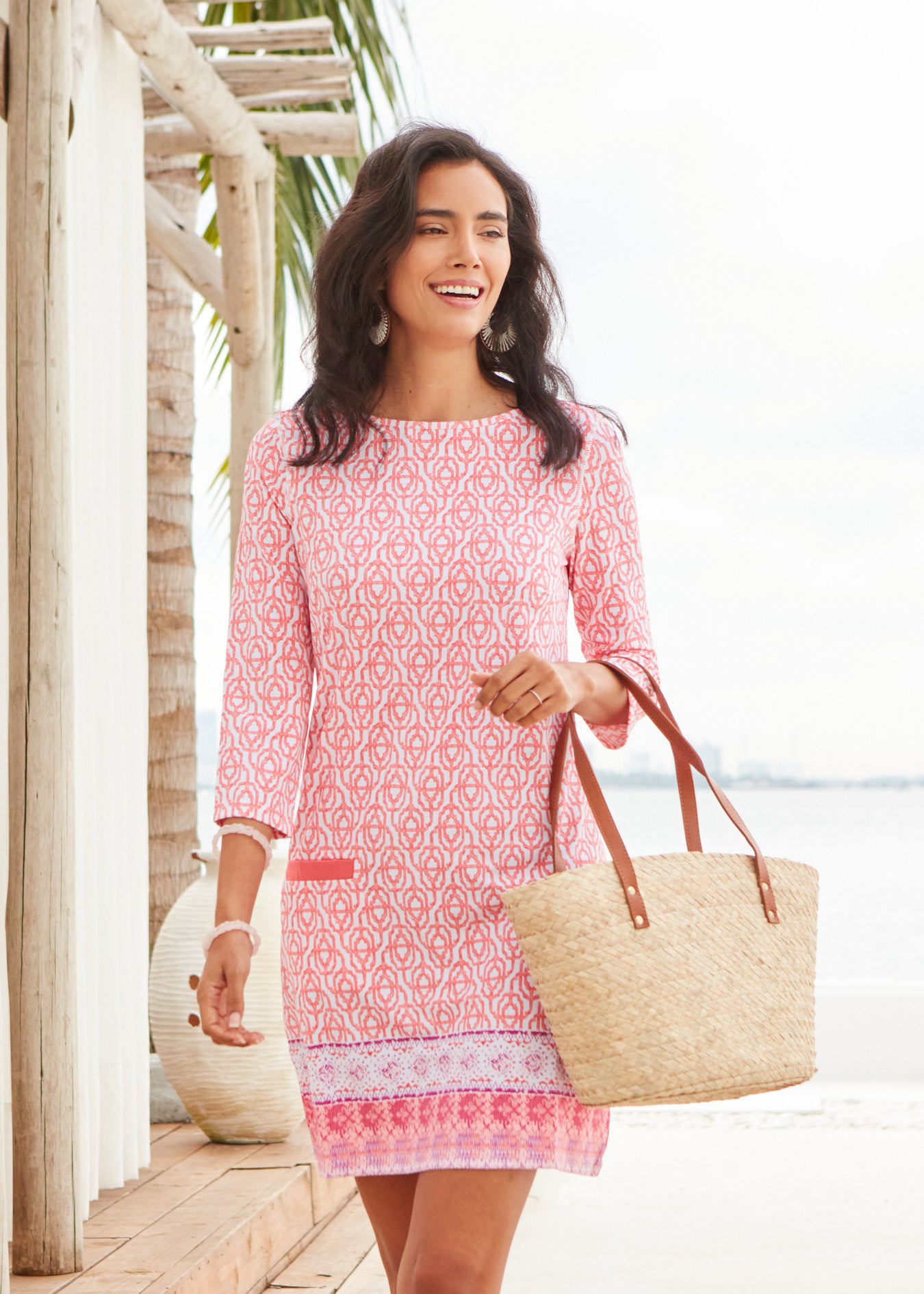 Dark haired woman wearing Napa Cabana Shift Dress holding bag.