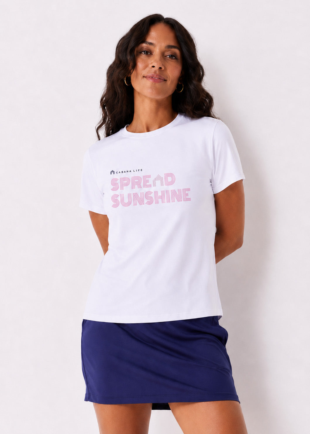 Woman wearing a white t-shirt with 'Spread Sunshine' text and a navy blue skirt on a white background
