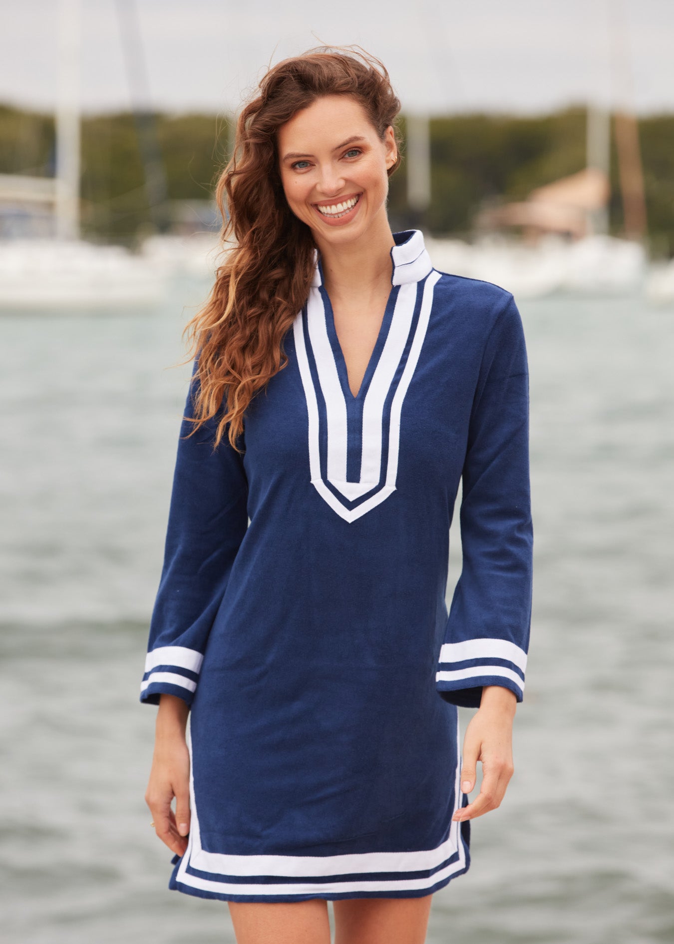 Brunette woman wearing Navy/White Terry Tunic at marina.