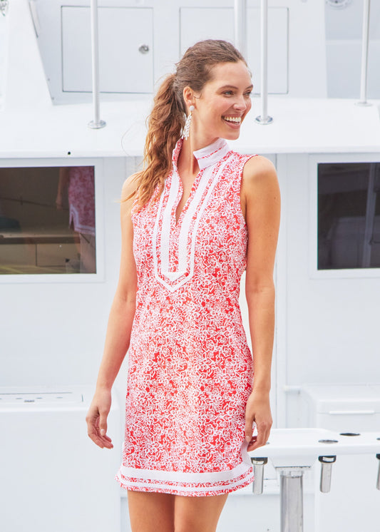 A woman looking into the distance in the Cabana Life sun protective Americana Sleeveless Tunic Dress in front of a boat.