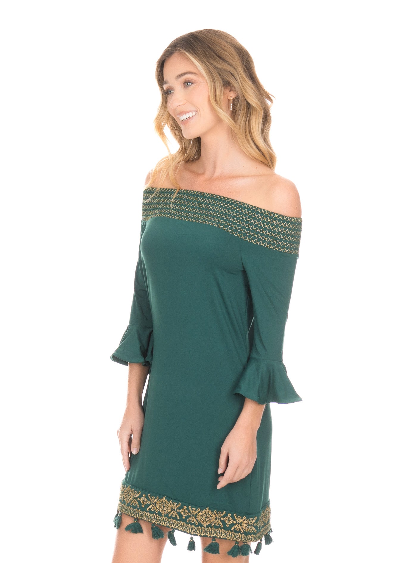 Side of blonde woman wearing the Emerald Metallic Embroidered Off The Shoulder Dress in front of white background.