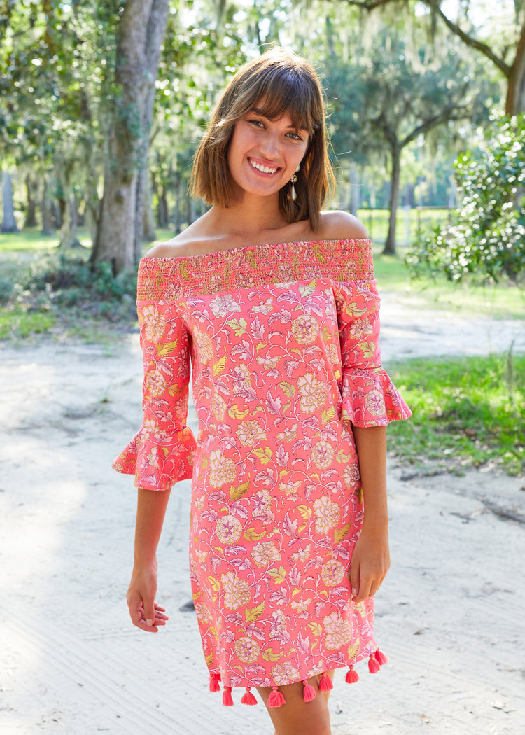 Brunette woman wearing Coral Metallic Off The Shoulder Dress.