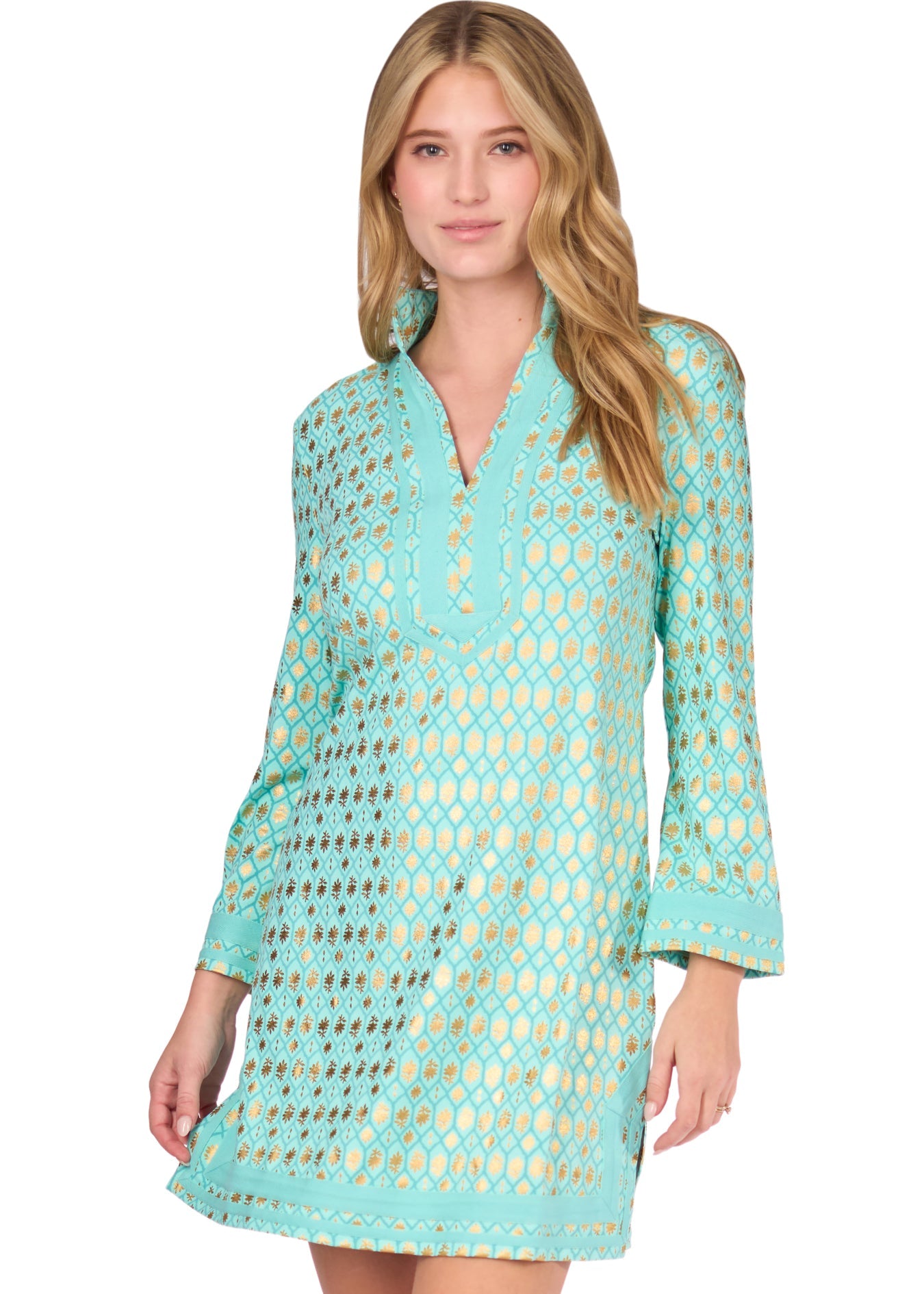 A blonde woman touching her hair wearing the Aqua Metallic Tunic Dress on a white background.