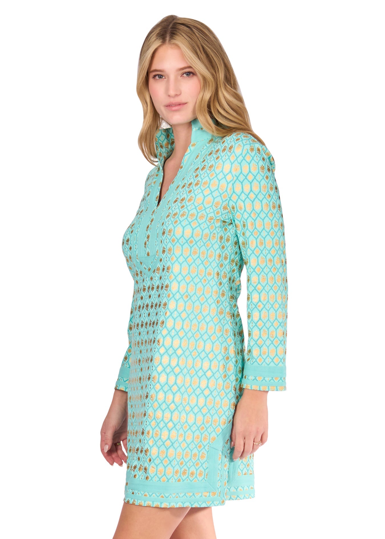 The side of a blonde woman wearing the Aqua Metallic Tunic Dress on a white background.