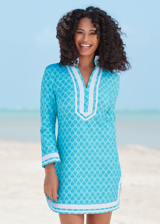 Black woman with curly hair wearing Amalfi Coast Tunic Dress on beach.
