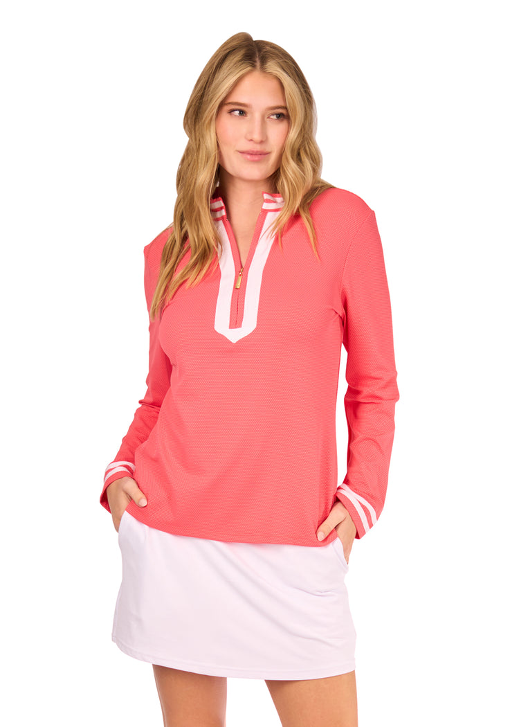 Woman in Coral Collared Quarter Zip and White Skort