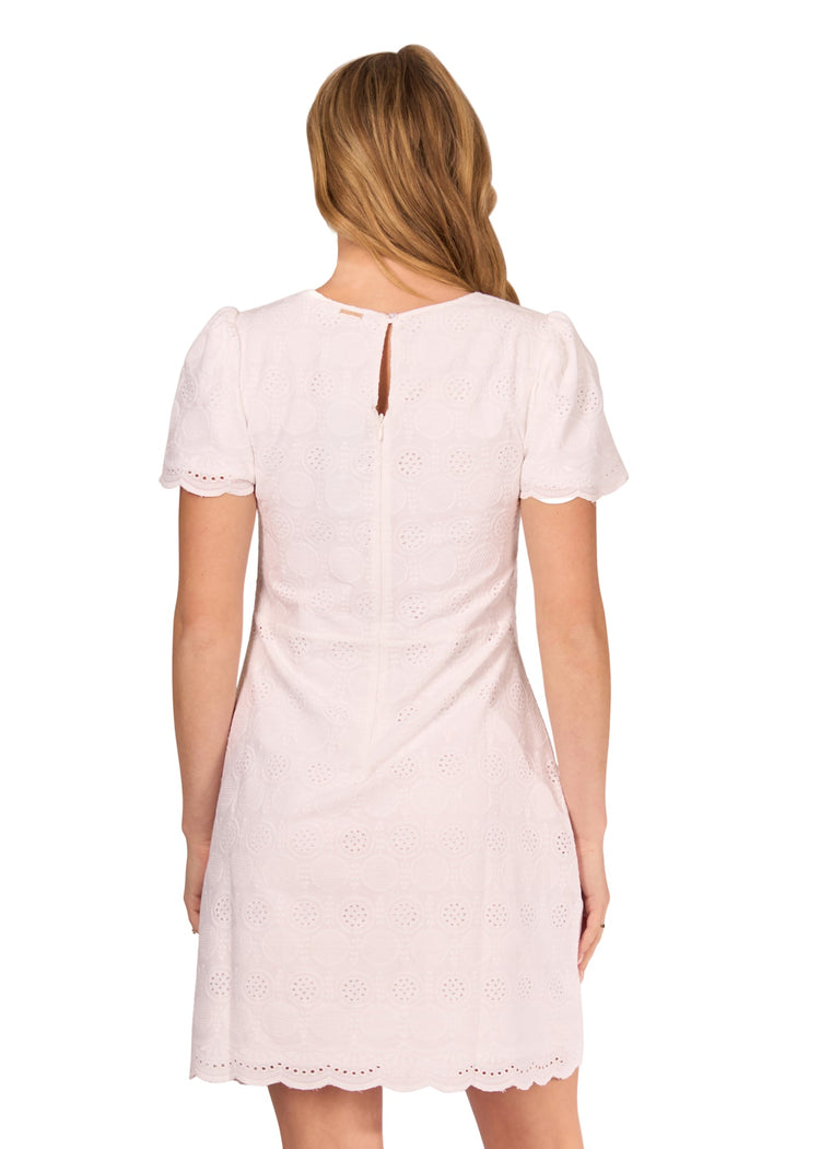 The back of a blonde woman wearing the White Eyelet Short Sleeve Dress on a white background.