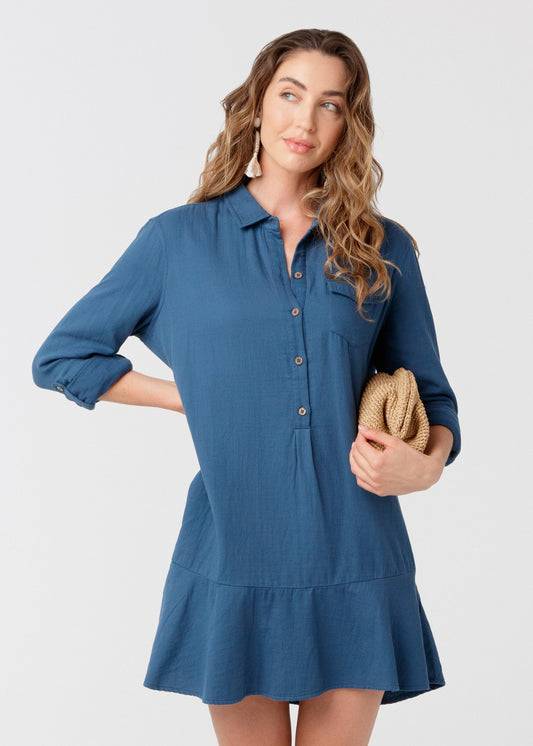 Woman wearing UPF 50+ Harbor Gauze Button Front Shirt Dress with a beige clutch purse