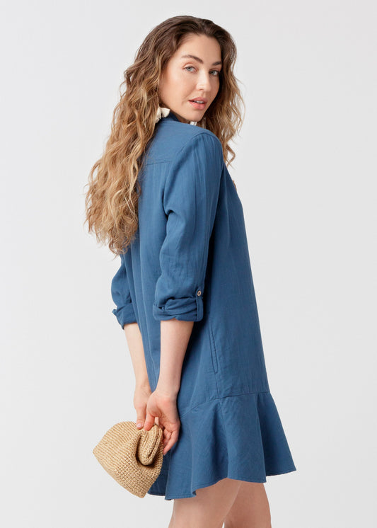 Woman wearing UPF 50+ Harbor Gauze Button Front Shirt Dress with a beige clutch purse
