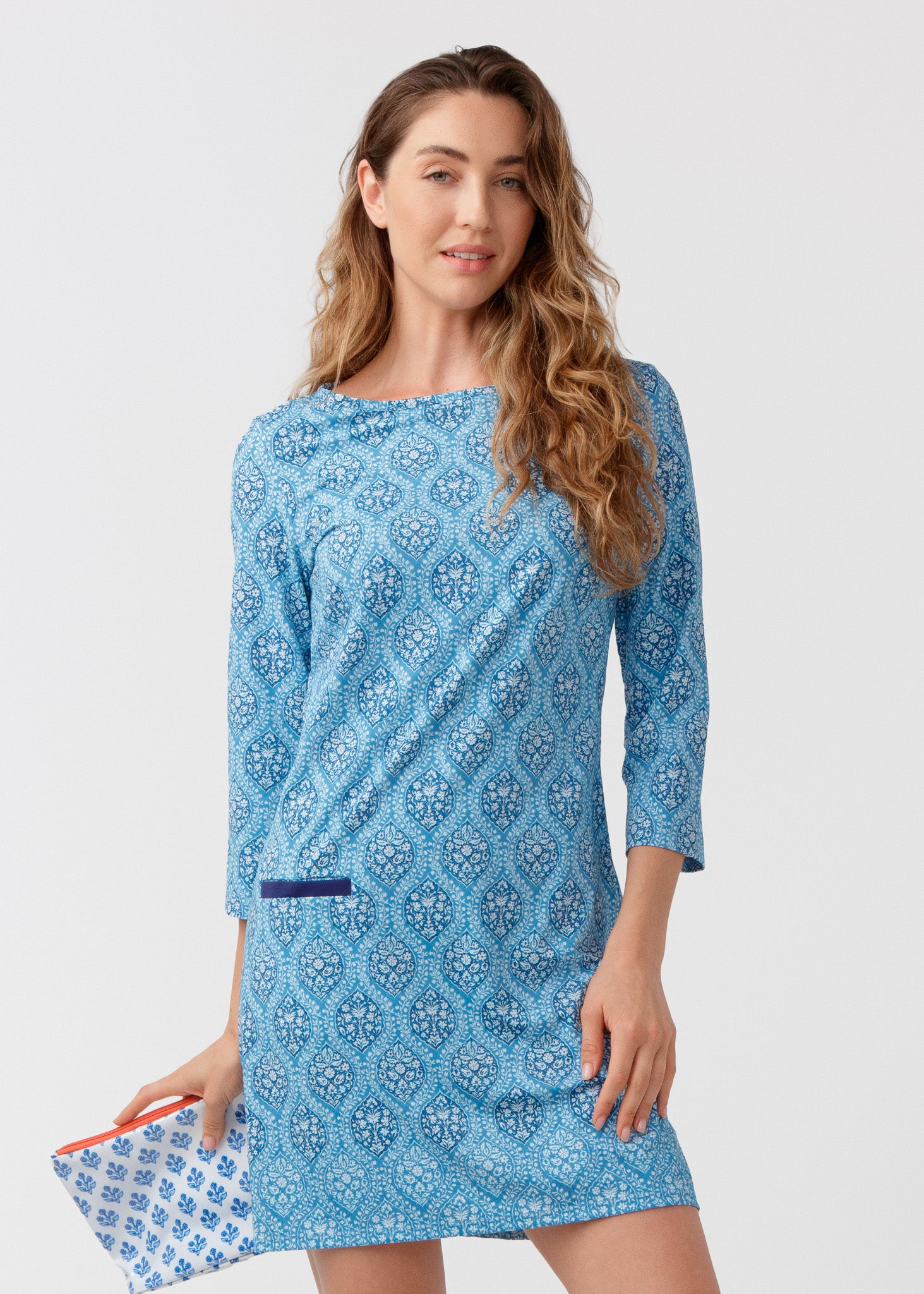 Woman wearing a blue patterned dress on a white background