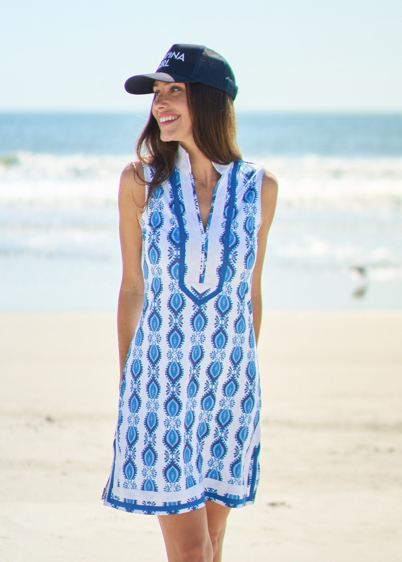 Woman looking to the side wearing San Sebastian Sleeveless tunic Dress with Cabana Girl Hat on beach.