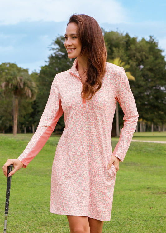 Woman in a pink dress standing on a golf course