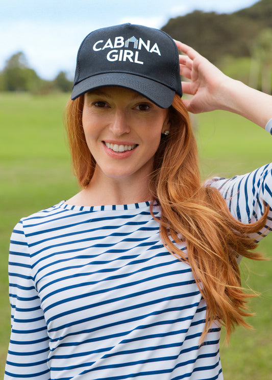 Woman wearing a 'Cabana Girl' cap in an outdoor setting