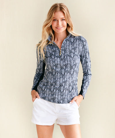 Woman wearing Sanibel Sport Zip Top with White Microfiber Short