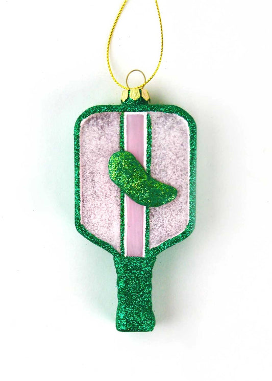 Decorative pickleball paddle ornament with glittery green and pink design topped with a green pickle on a white background