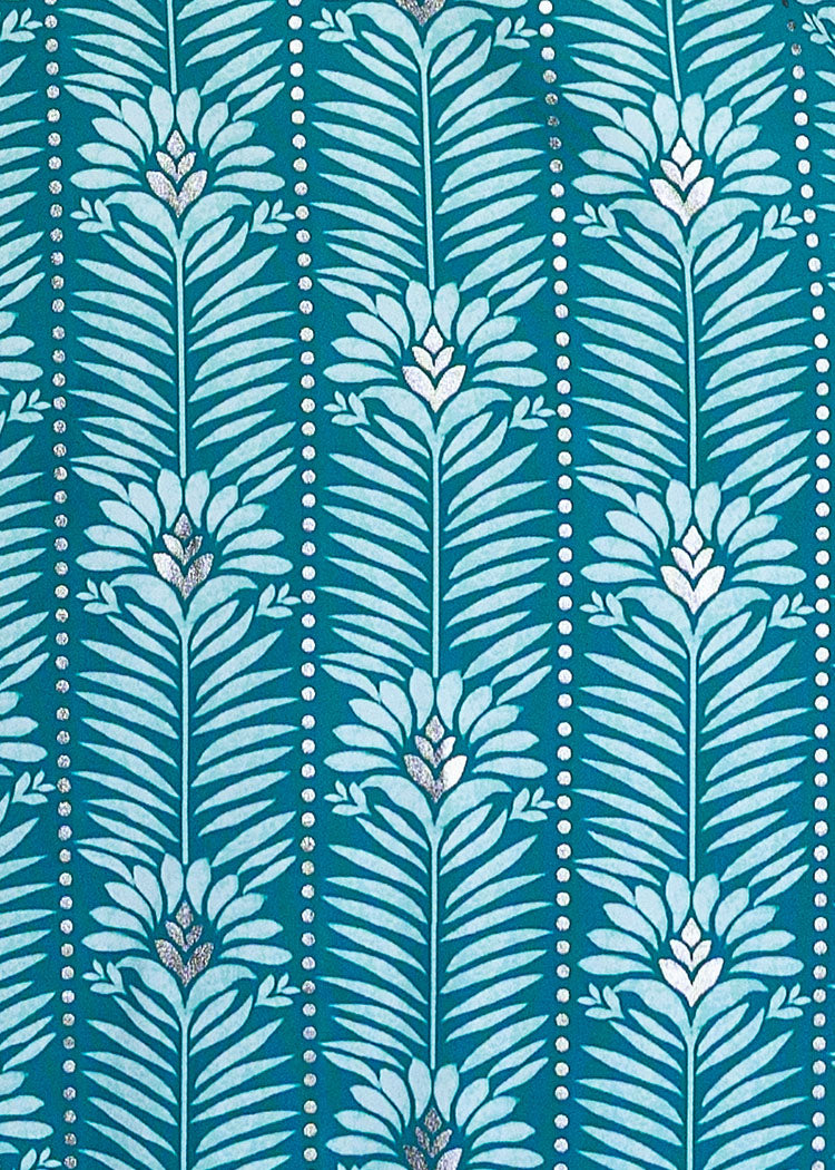 A close-up of a teal and light blue patterned fabric featuring vertical leafy motifs and dotted lines.