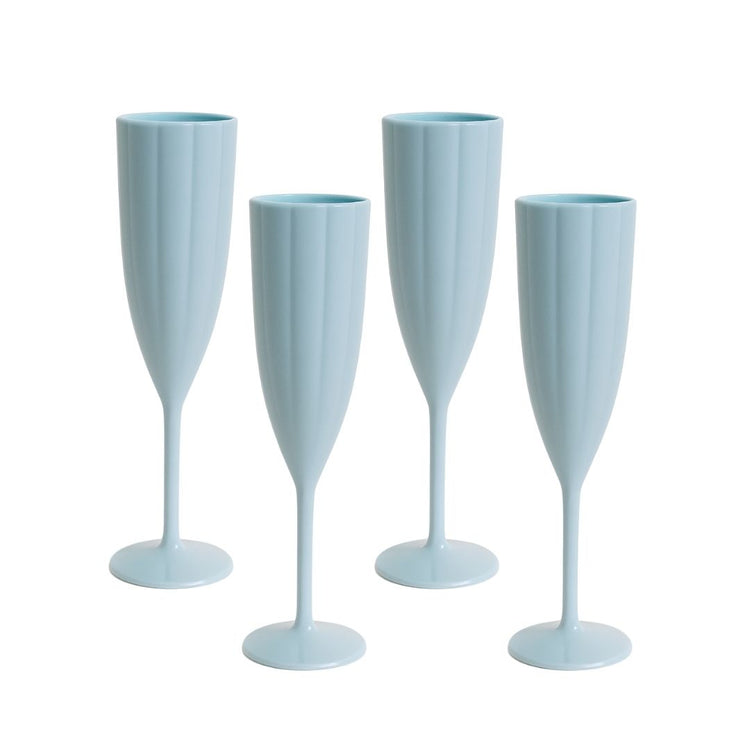 Four light blue champagne flutes on a white background