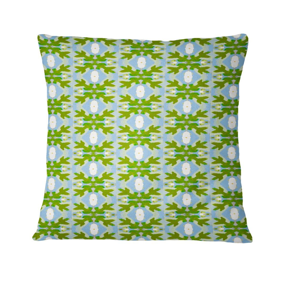 Decorative pillow with a green and blue pattern on a white background