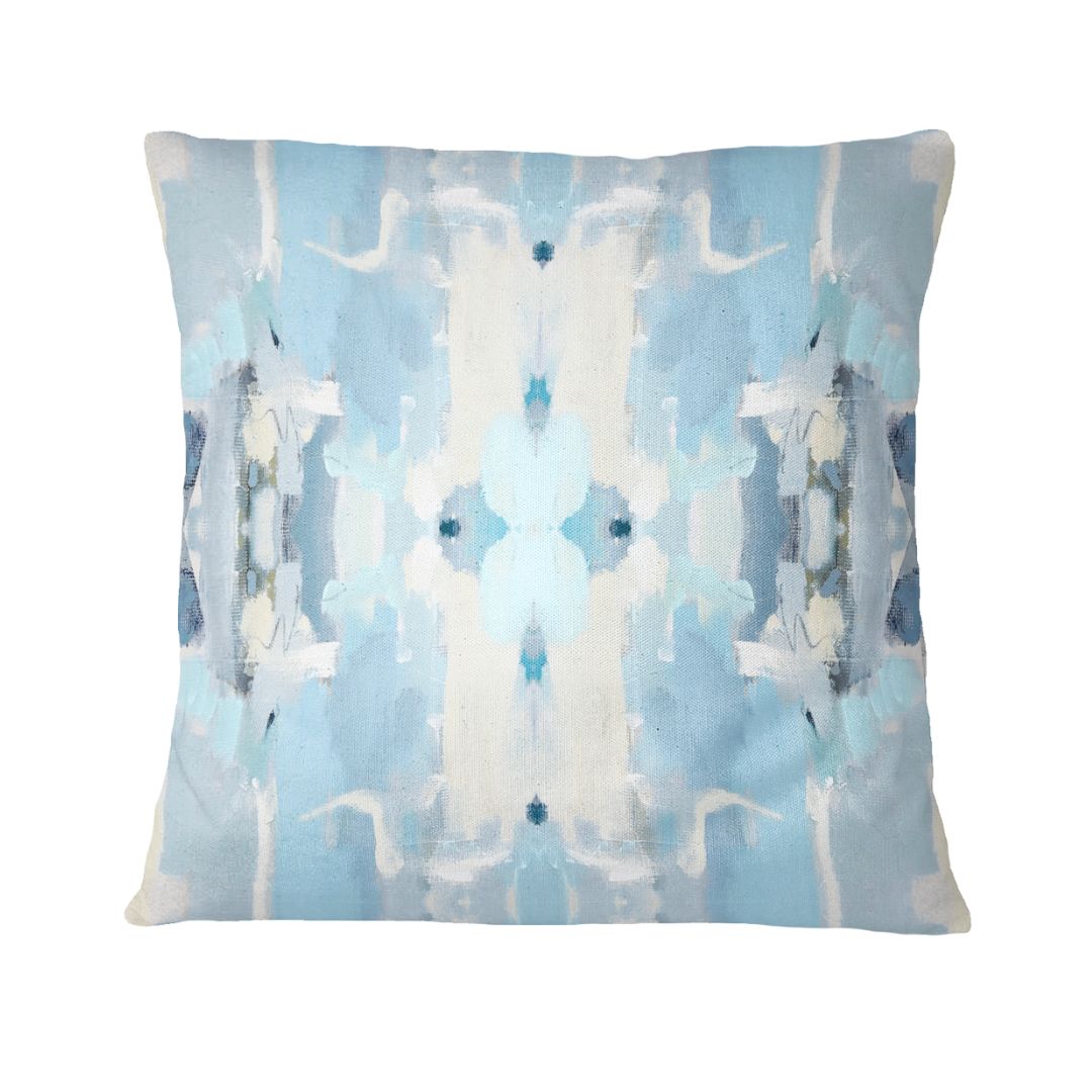 Decorative pillow with abstract blue and white pattern on a light blue background
