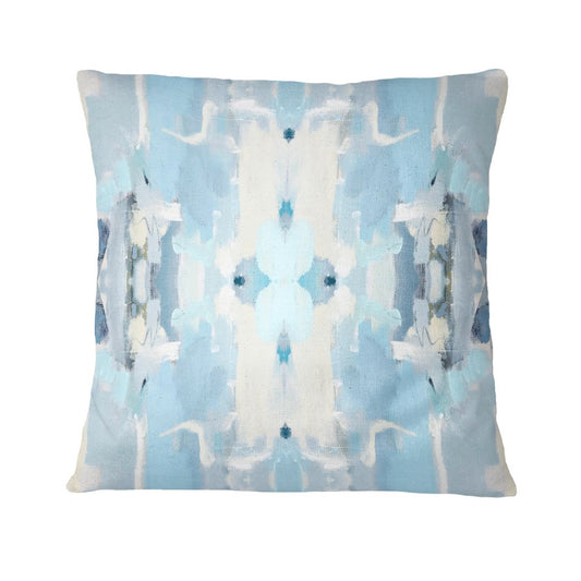 Decorative pillow with abstract blue and white pattern on a light blue background