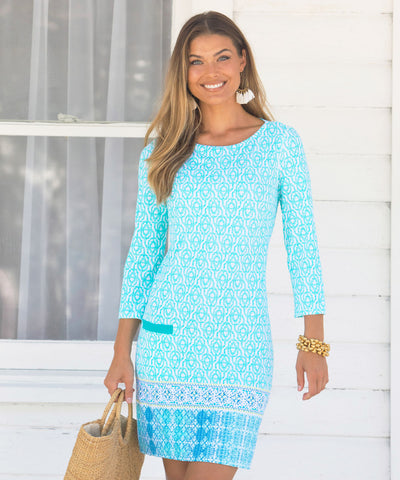 Woman wearing a teal printed dress.