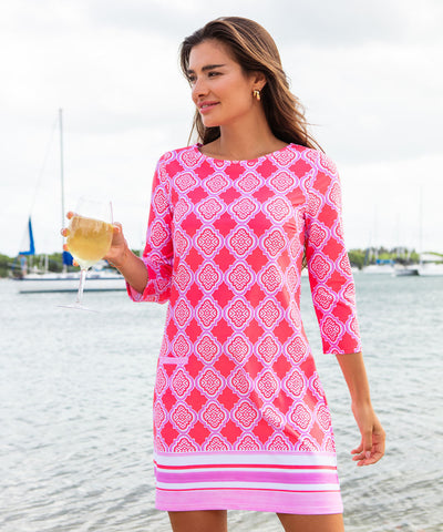 Woman wearing a coral printed dress.