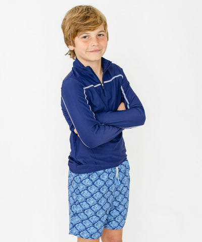 A boy wearing Cabana Life's sun protective swimwear.