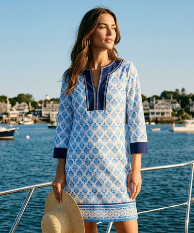 Woman wearing a blue and white printed dress.