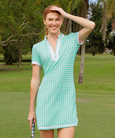 Woman wearing a green basketweave sport dress on a golf course.