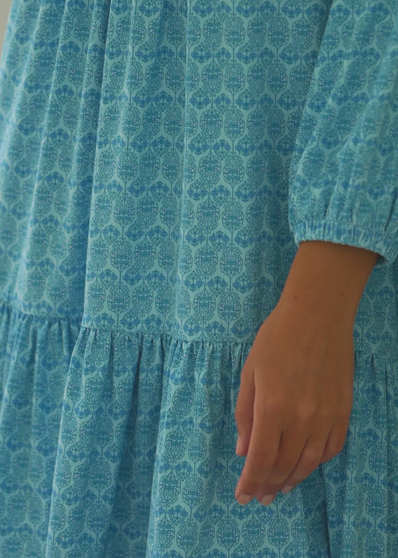 A video of a brunette woman wearing the Cabana Life sun protective Rosemary Beach Relaxed Dress outside.